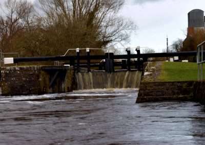 Water spilling over the Tail gates of Upper Ballyellen Lock on river Barrow. The river is in Flood.