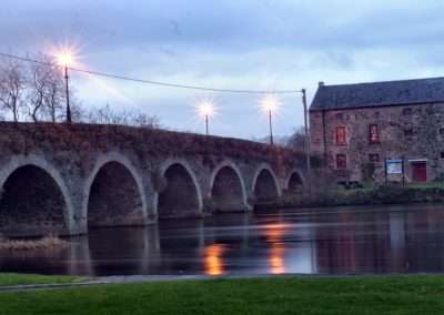 Bridge and malt stores on river Barrow at dusk in Goresbridge, Ireland