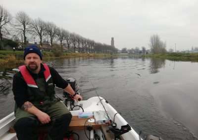 John Creaney driving a small boat on river Barrow at Athy, Kildare, Ireland.