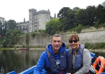 Jimmy Dunne & Sarah Dunne on blue boat on river Nore under Castle in Kilkenny