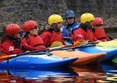 Trainee kayakers on the river nore in a group