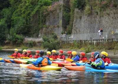 Kayakers receiving instruction on the river Nore