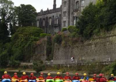Kayaks rafted together in Kilkenny under the castle